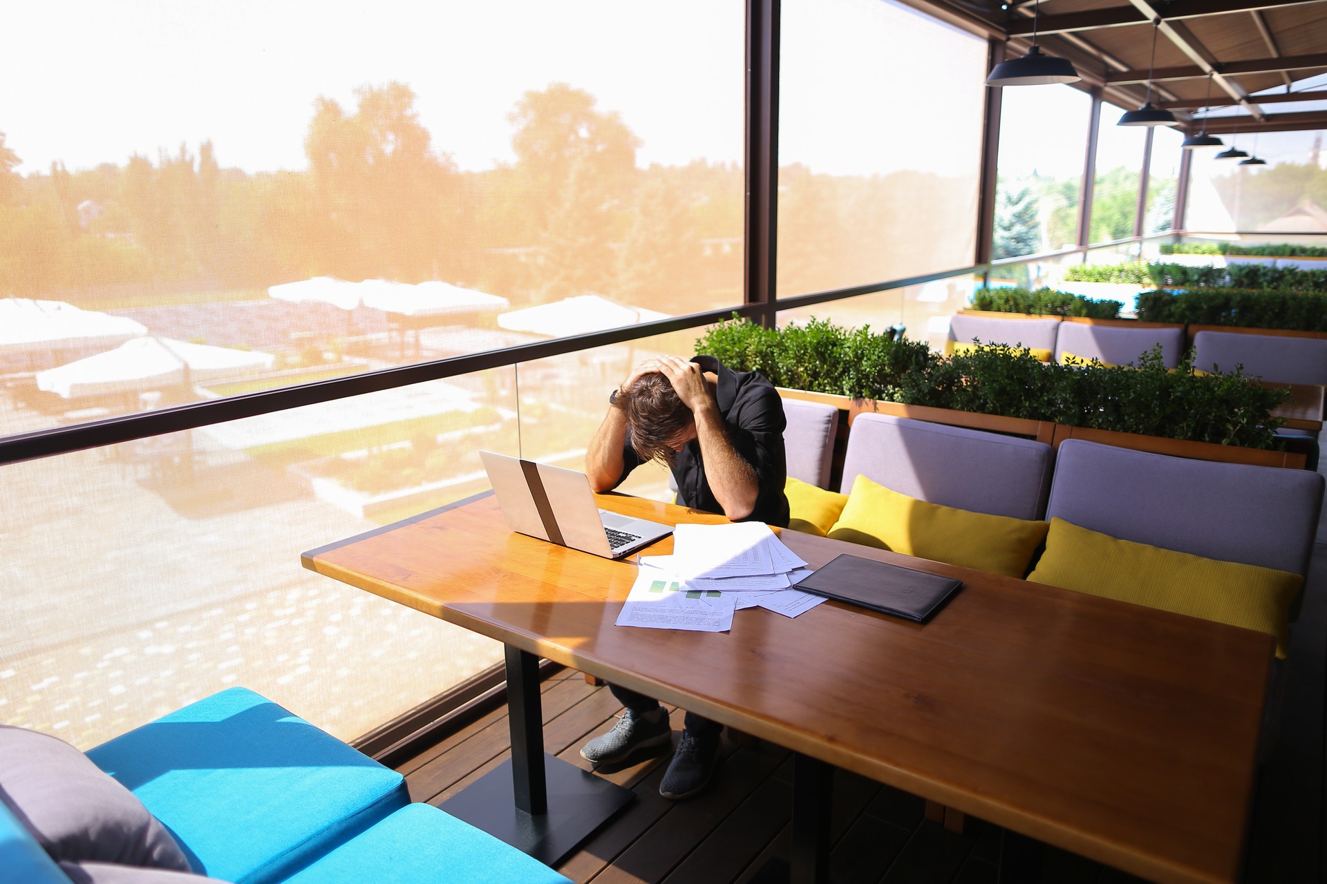 Freelance copywriter rewrite text on laptop at cafe table