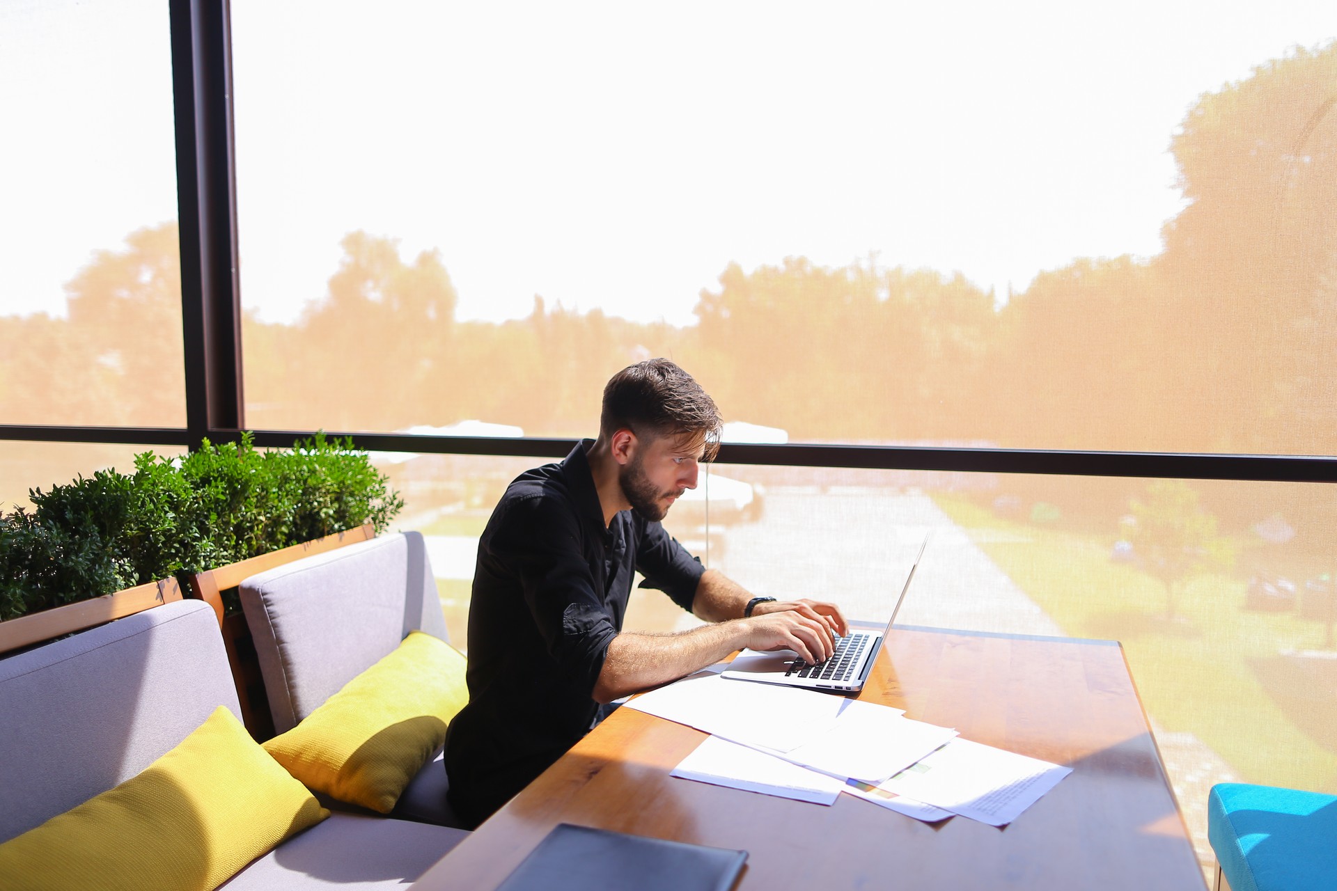 Freelance copywriter rewrite text on laptop at cafe table